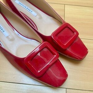Red patent leather pumps